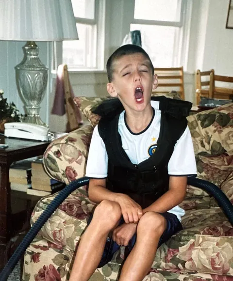 Charlie as a kid, mid-treatment in his airway clearance vest
